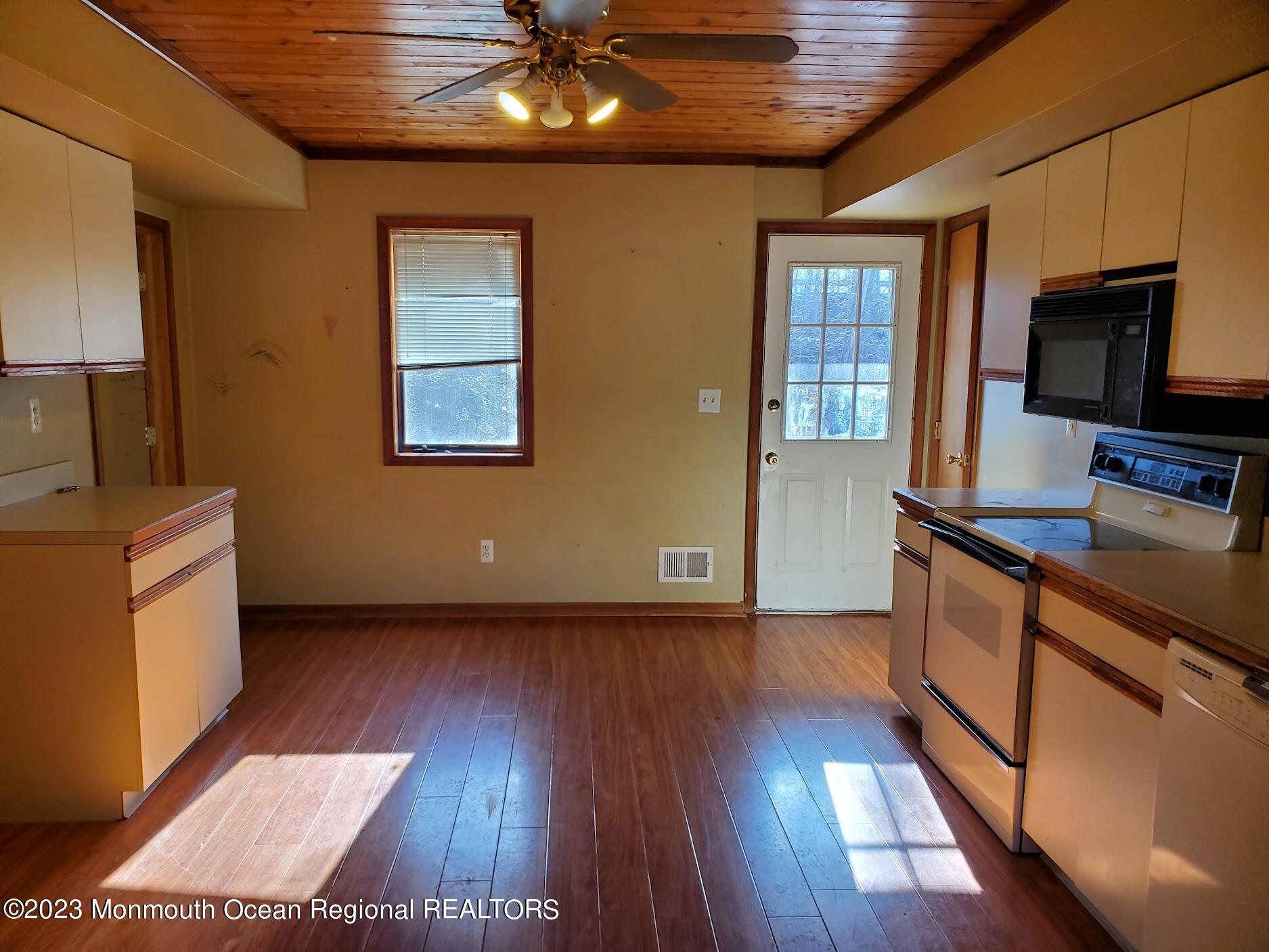 16 Pinewood Road Howell, NJ 07731 - Photo 13 of 28 a kitchen with stainless steel appliances wooden floors and granite counter tops