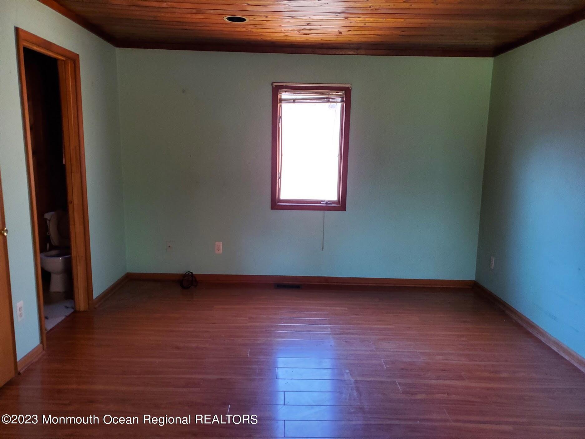 16 Pinewood Road Howell, NJ 07731 - Photo 15 of 28 a view of an empty room with wooden floor and a window