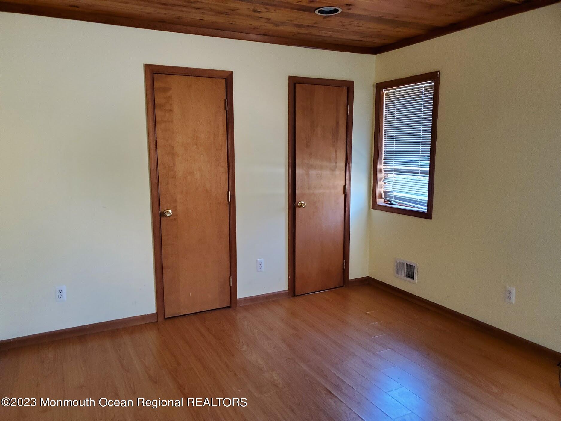16 Pinewood Road Howell, NJ 07731 - Photo 19 of 28 a view of an empty room with wooden floor and closet