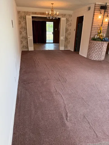 a view of a big room with closet and mirror