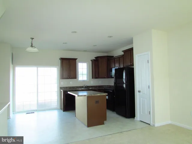 a view of a kitchen with granite countertop and a sink