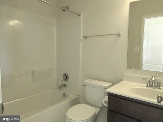 a view of a room with furniture and wooden floor