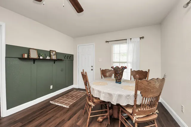 a view of a dining room with furniture and window