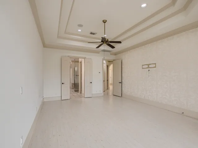 a bathroom with a tub a double vanity sink and a mirror
