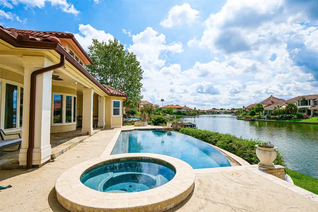a view of a house with swimming pool and sitting area
