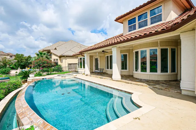 a view of a house with swimming pool and porch