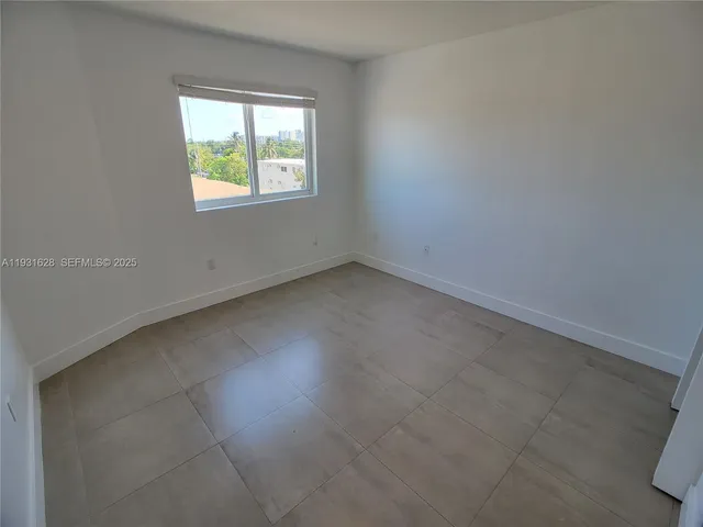an empty room with an entrance to other room