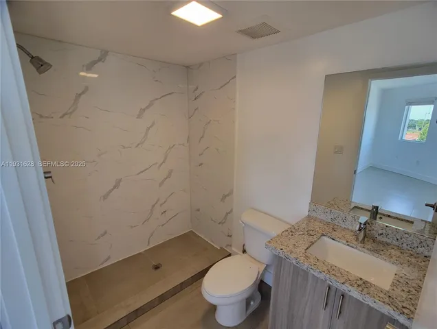 an empty room with windows and entrance