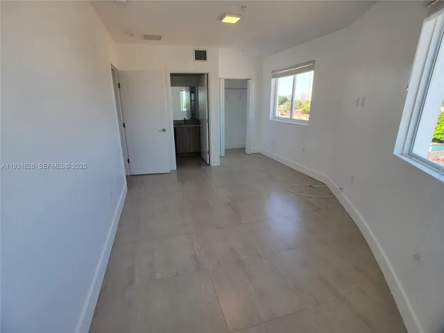 a view of an empty room with windows