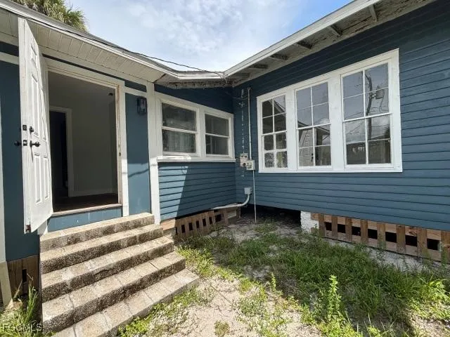 a view of a house with backyard and sitting area