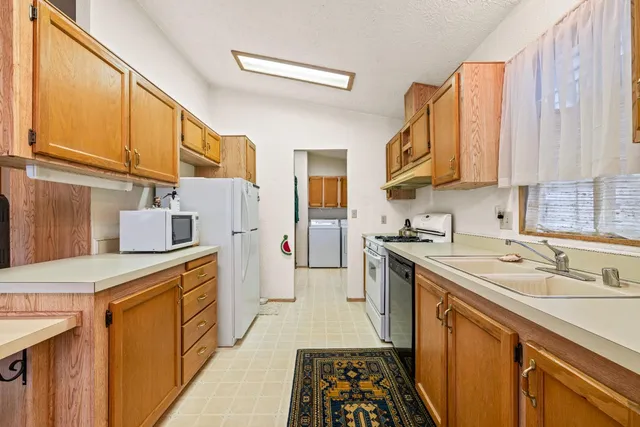 a kitchen with a sink stove and cabinets