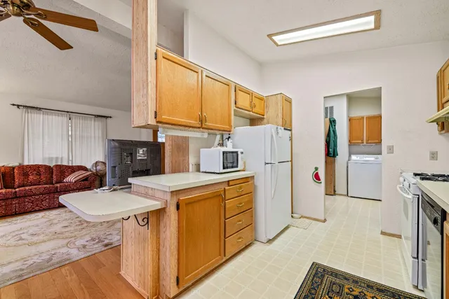 a kitchen with stainless steel appliances granite countertop a sink a stove and a refrigerator