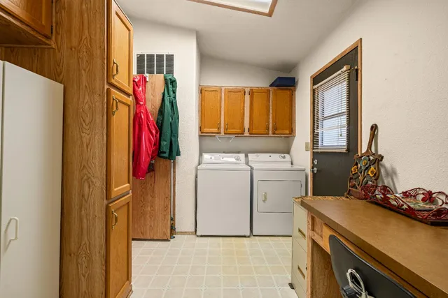 a view of a storage and utility room with washer and dryer