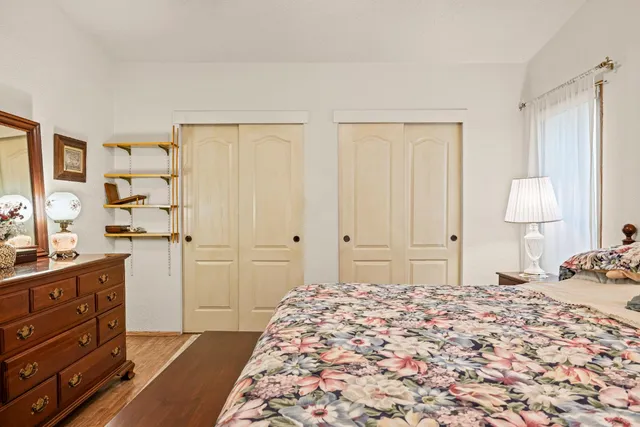 a bedroom with a bed and a dresser