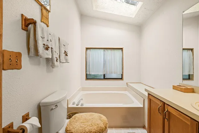 a bathroom with a tub sink and toilet