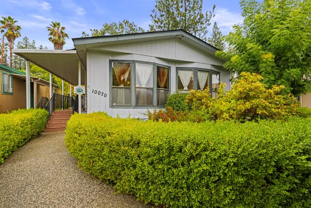 a view of a house with a small yard and plants