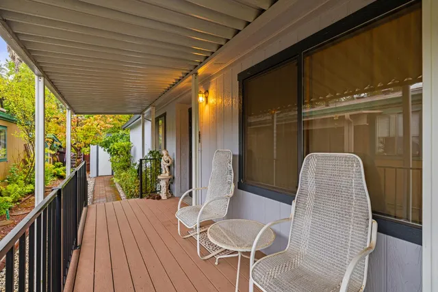 a view of a balcony with wooden floor and outdoor space