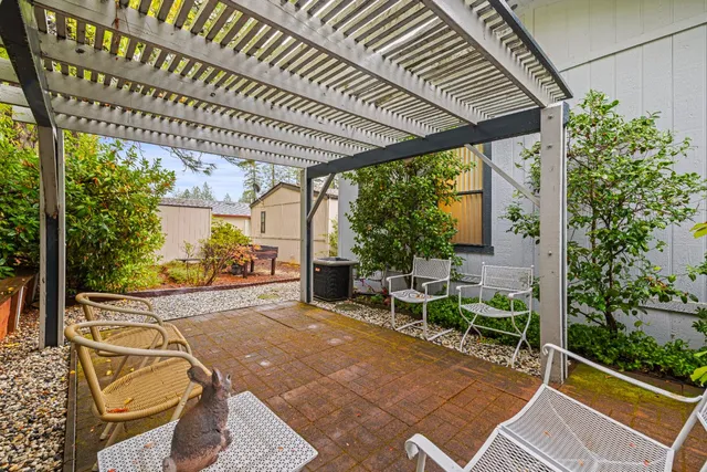 a view of a porch with chairs and backyard