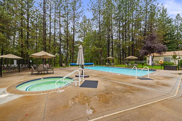 a view of a tennis ground with large trees