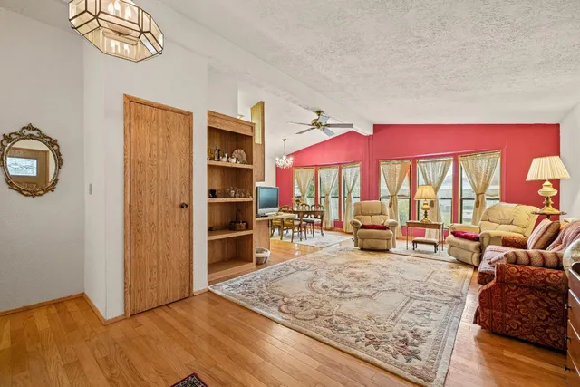 a living room with furniture large window and flat screen tv