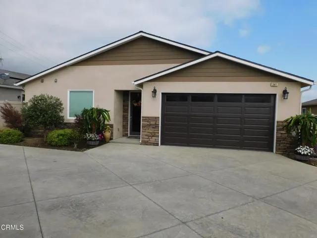 a view of a house with backyard porch and sitting area
