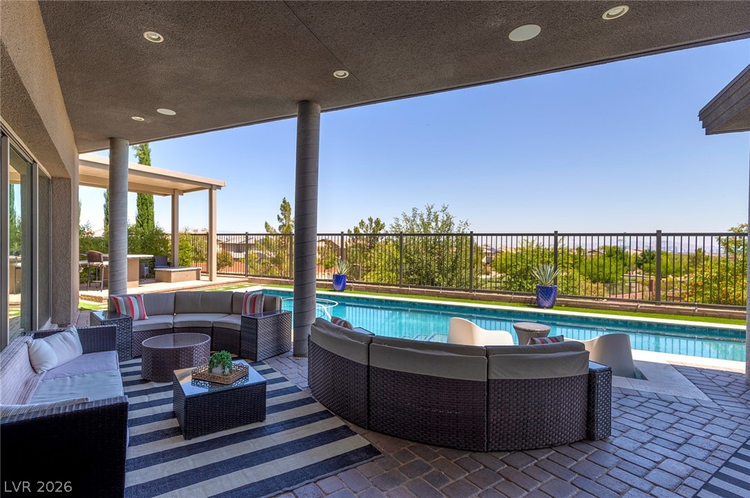 6014 Willow Ridge Court Las Vegas, NV 89135 - Photo 75 of 99 An inviting covered patio featuring a refreshing pool with breathtaking views, perfect for outdoor living.