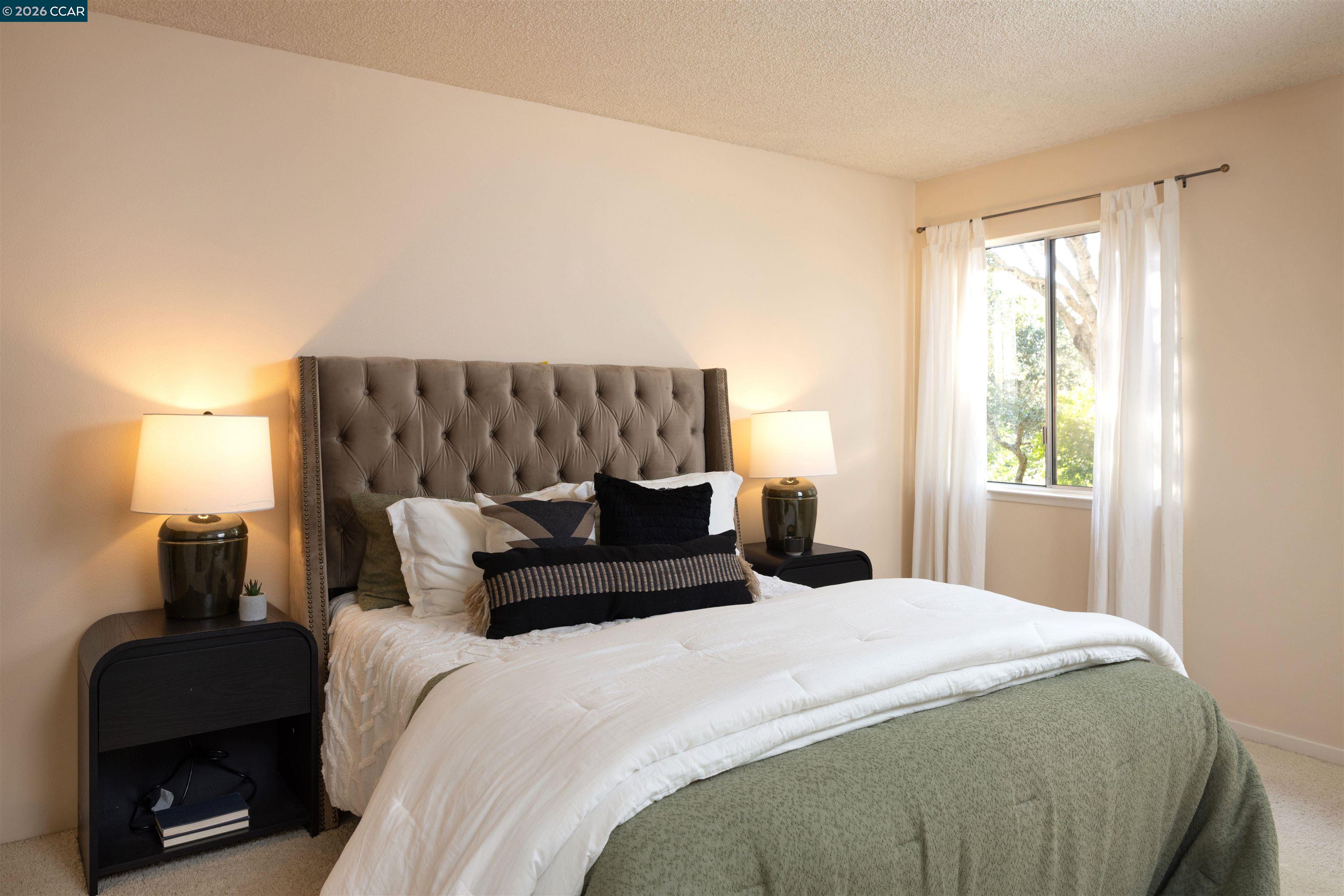 12 Marquard Road Carmel Valley, CA 93924 - Photo 19 of 36 a bedroom with a bed a couch and a window