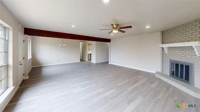 a view of an empty room with a fireplace