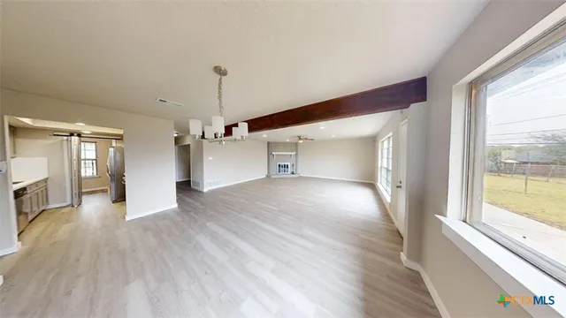 a view of a kitchen with wooden floor and a ceiling fan