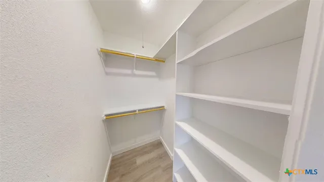 a view of an empty walk in closet