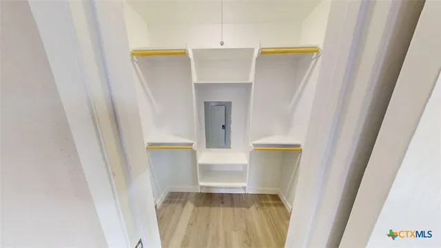 a view of walk in closet with a fireplace
