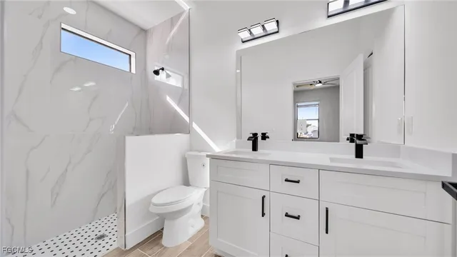 a bathroom with a toilet a sink and a mirror