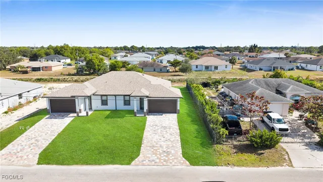 an aerial view of a house with a yard