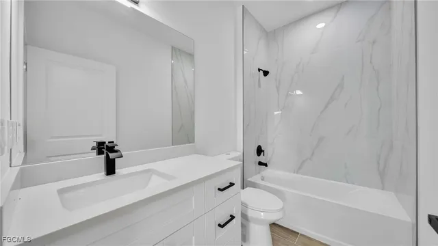 a bathroom with a tub a sink and a shower