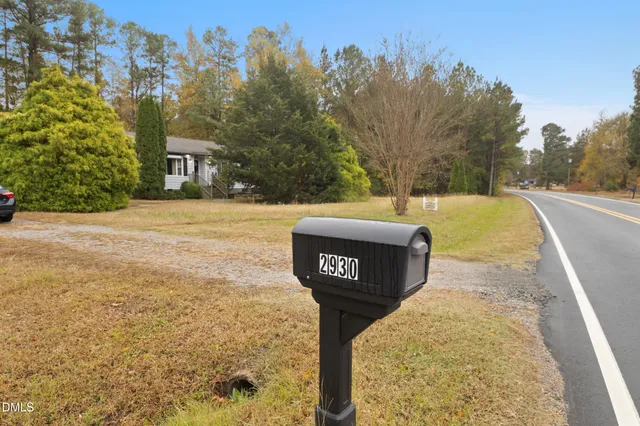a view of a house with a yard and garage