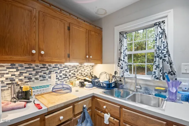 a kitchen with stainless steel appliances granite countertop a stove a sink dishwasher and cabinets with wooden floor