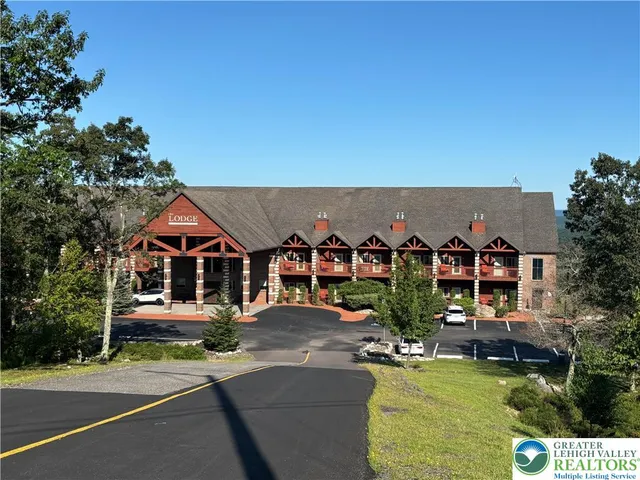 an aerial view of a house with swimming pool garden and outdoor seating