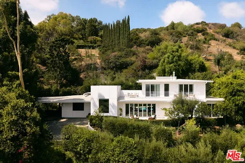 a view of a house with a yard and sitting area