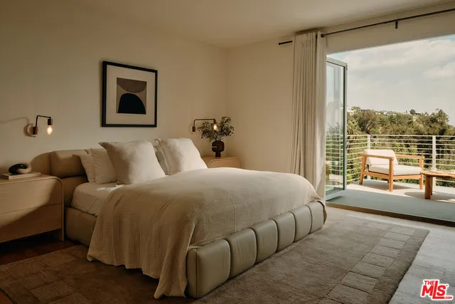 a bedroom with a bed and glass window