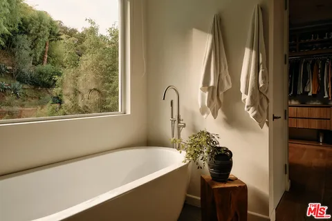 a bathroom with a bathtub and a window