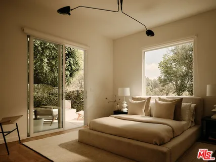 a living room with a large window and a wooden floor