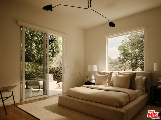 a living room with a large window and a wooden floor