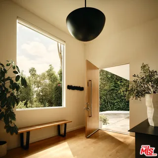 a view of a floor to ceiling window and a tree