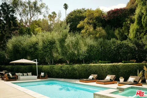 a swimming pool with barbeque oven outdoor seating and yard