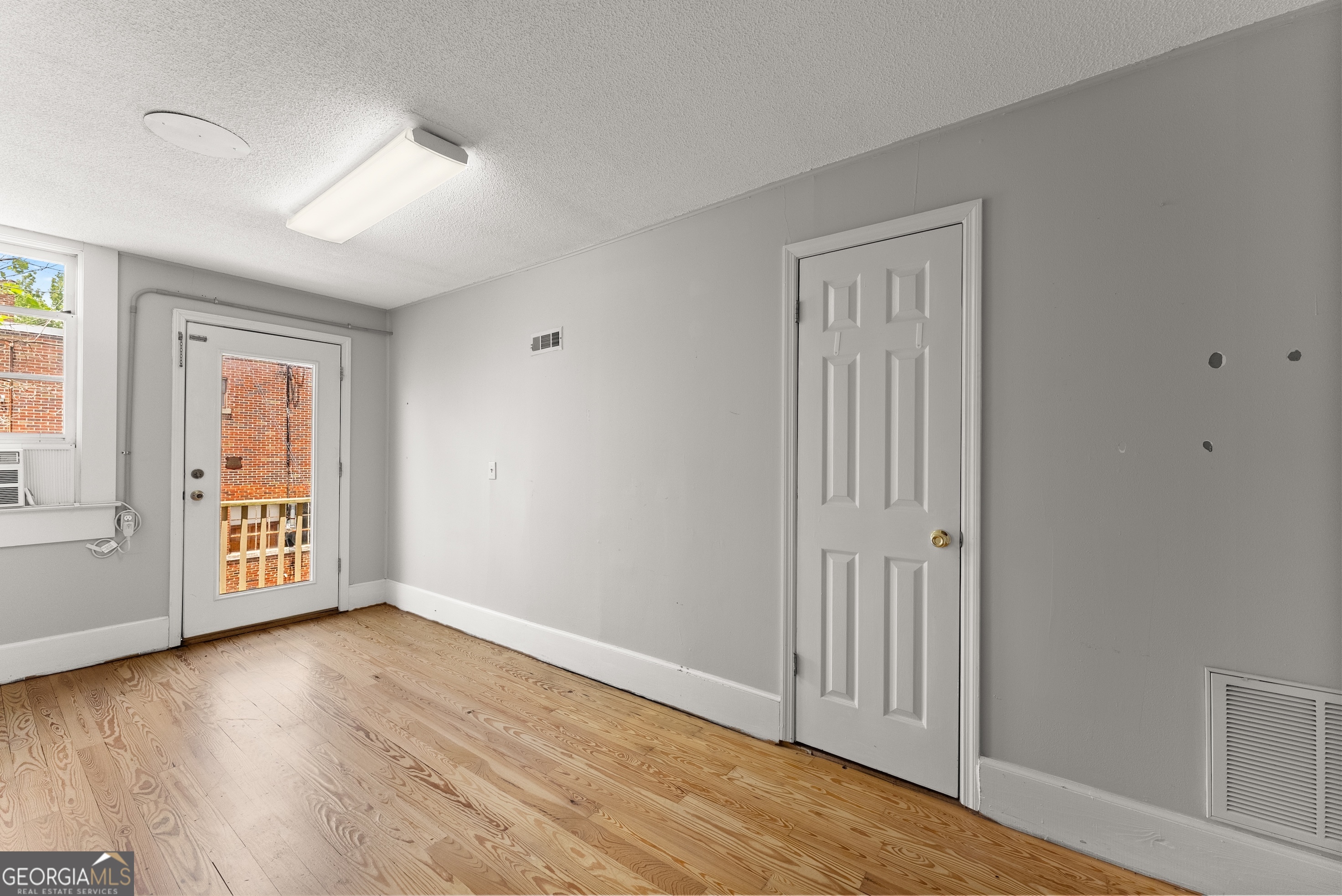 592 North Main Street Cornelia, GA 30531 - Photo 17 of 41 a view of an empty room with wooden floor and a window