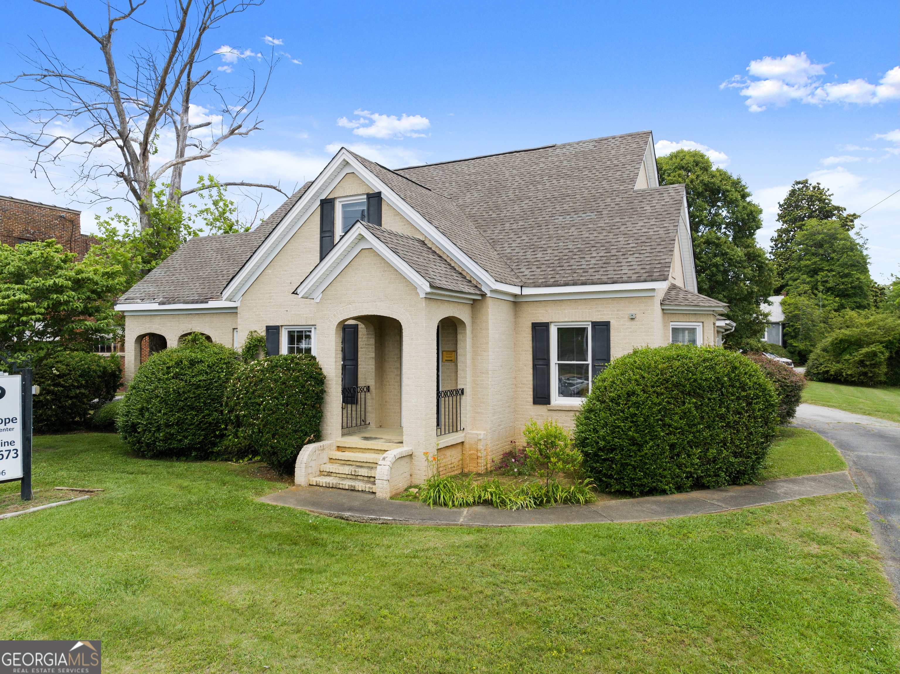 592 North Main Street Cornelia, GA 30531 - Photo 2 of 41 a front view of a house with a garden