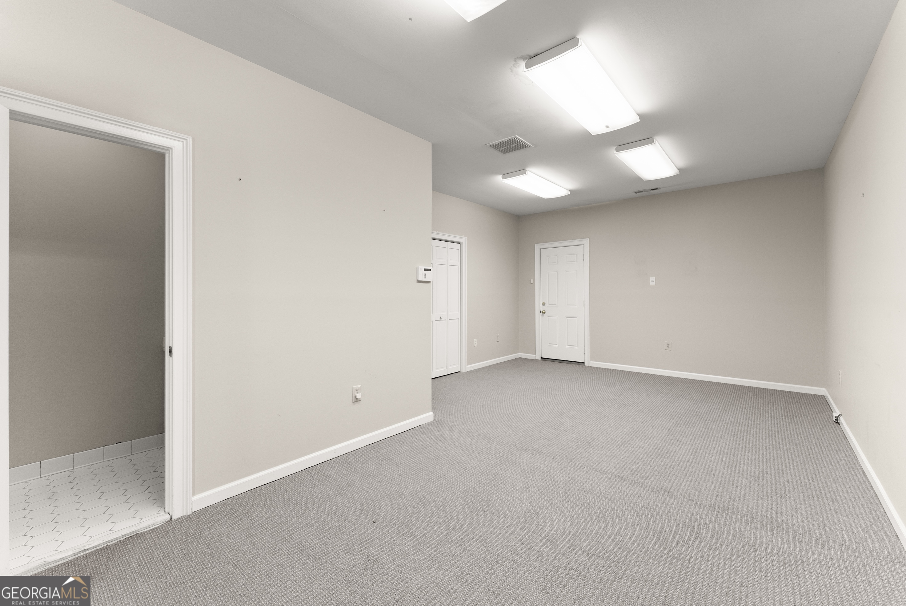 592 North Main Street Cornelia, GA 30531 - Photo 21 of 41 an empty room with a ceiling fan and window