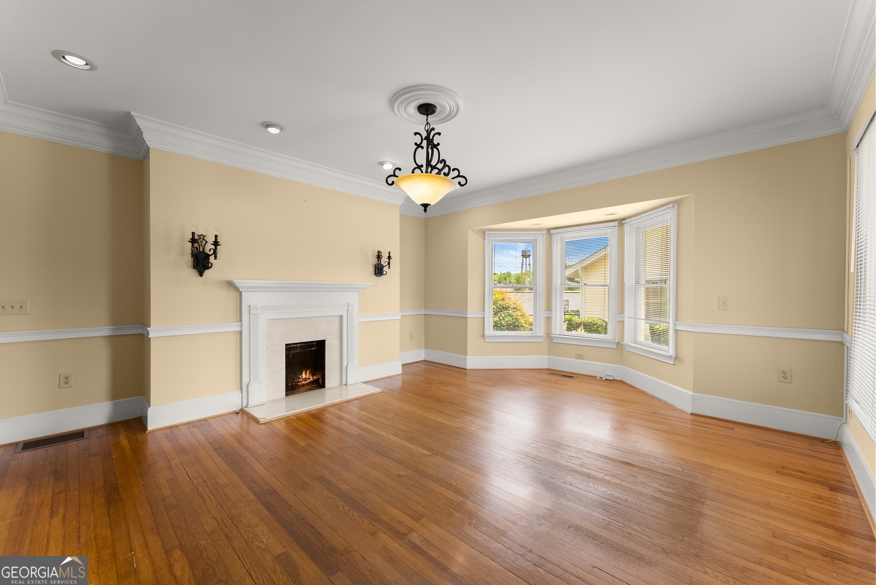 592 North Main Street Cornelia, GA 30531 - Photo 6 of 41 a view of a livingroom with wooden floor a fireplace and windows