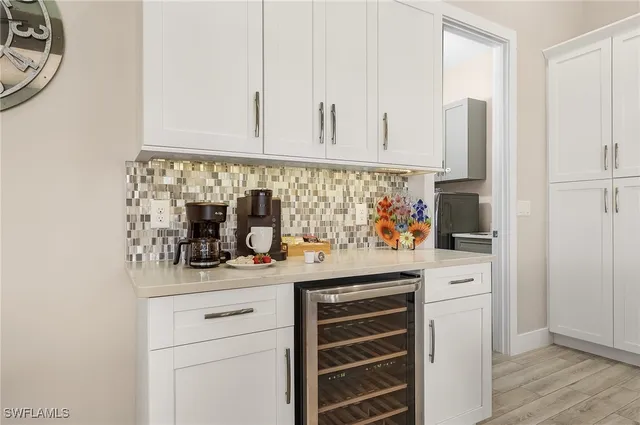 a kitchen with stainless steel appliances white cabinets and a sink