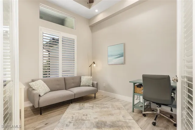 a livingroom with workspace and a couch